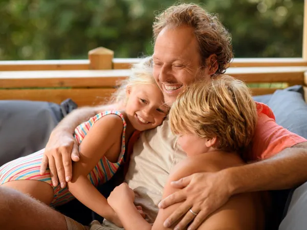 Vater und Kinder mit Roan auf dem Wohnzimmersofa.